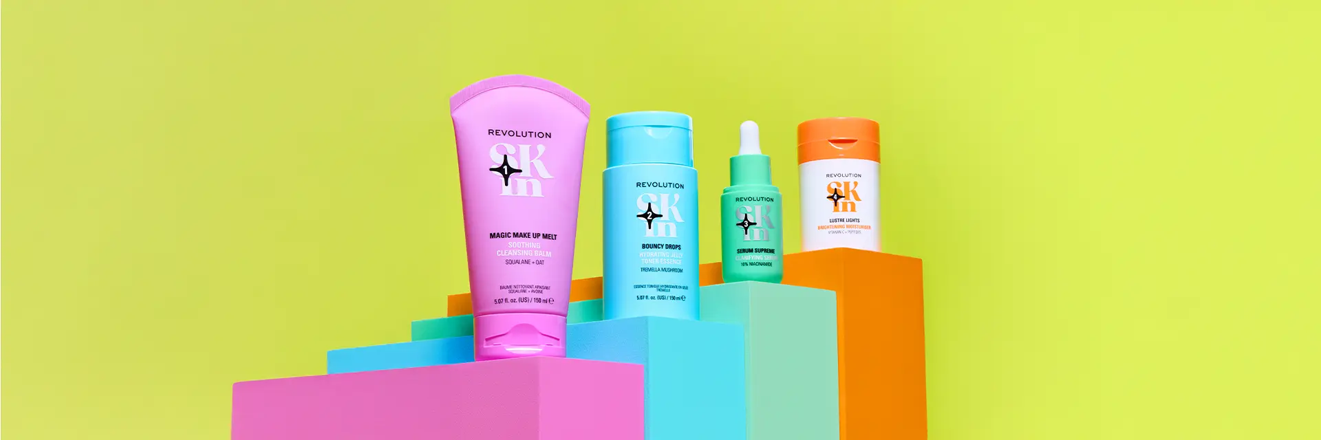 Revolution haircare, skincare and styling product range arranged on colourful podiums.