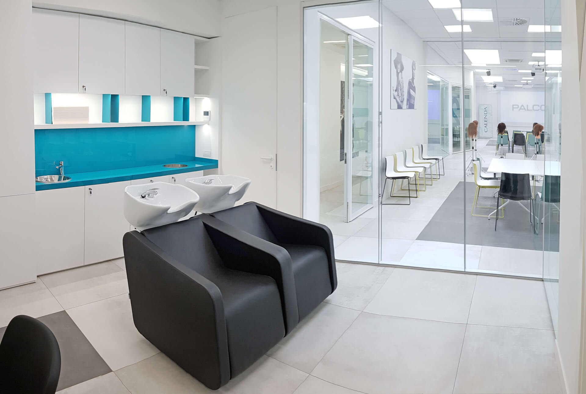 Calenda salon interior with backwash stations and styling area branded 'Palco'.