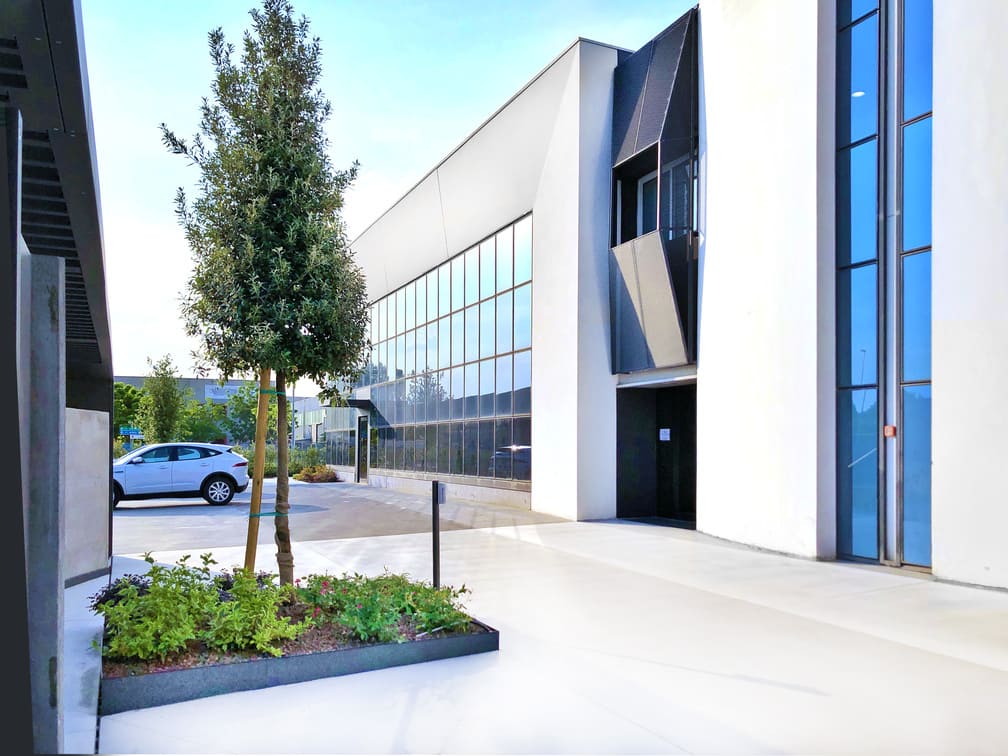 Modern glass-and-concrete exterior of Calenda's Veggiano (Padua) headquarters.