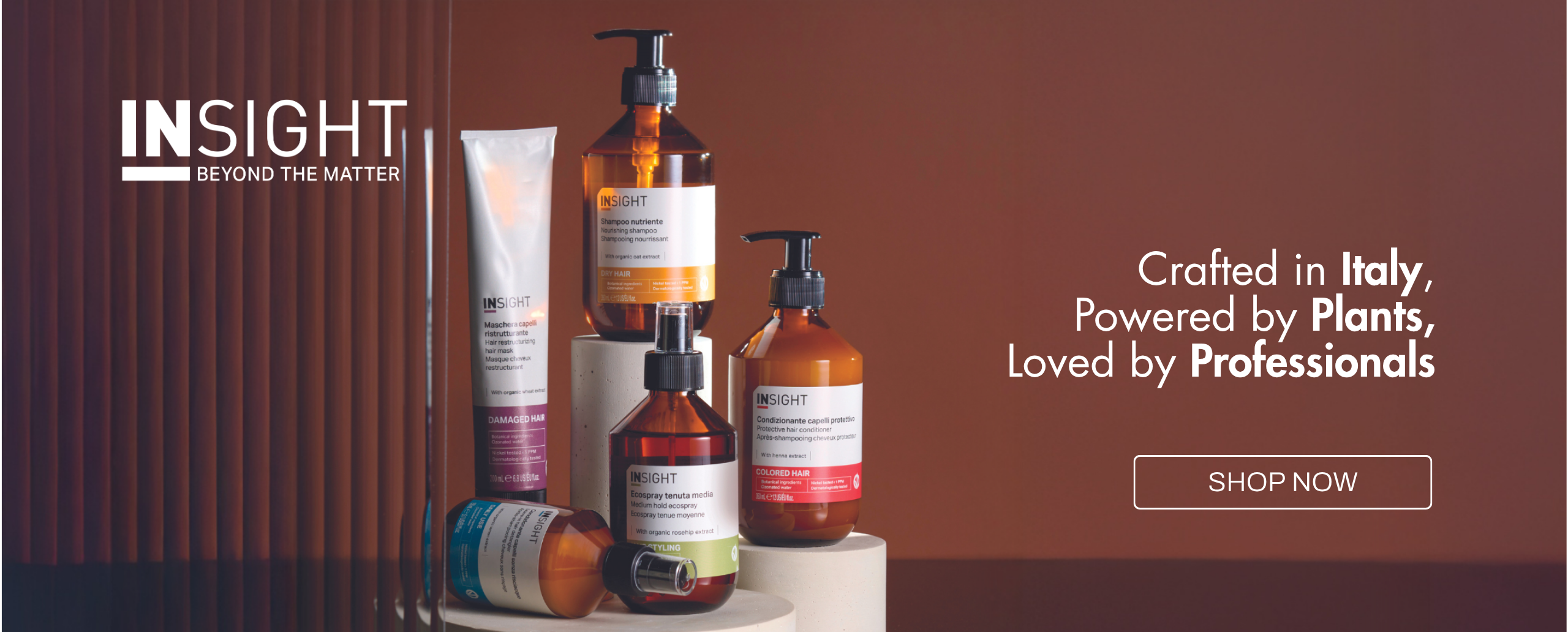 In-Sight 'Beyond the Matter' haircare line arranged on podiums with the tagline 'Crafted in Italy, Powered by Plants, Loved by Professionals.'