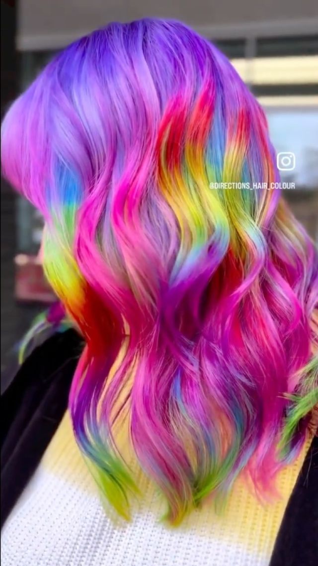 Long wavy hair styled with rainbow Directions hair colour — reference work from Morocutti's salon-supply catalogue (@directions.hair.colour).